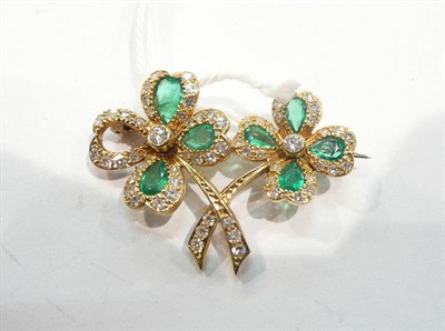 Lot 278 - An emerald and diamond set four leaf clover brooch (one stone missing)