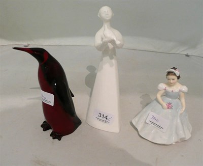 Lot 314 - A Royal Doulton flambe penguin and two Royal Doulton figures 'The Bridesmaid' HN2196 and...