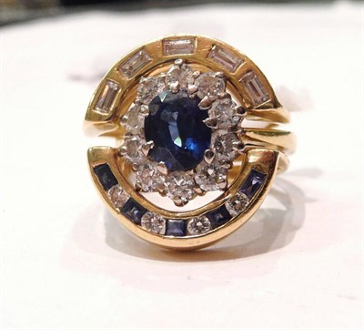 Lot 414 - An 18 carat gold sapphire and diamond cluster ring, within a border of round brilliant cut diamonds