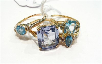 Lot 417 - Two 9 carat gold blue topaz rings, a ring stamped '14K' and another ring (4)