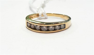 Lot 422 - An 18 carat gold diamond half eternity ring in a channel setting