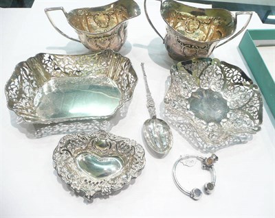 Lot 451 - A silver sugar and cream, two bonbon dishes, hard stone set key ring, two others and a spoon