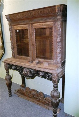 Lot 530 - Carved oak glazed bookcase on stand