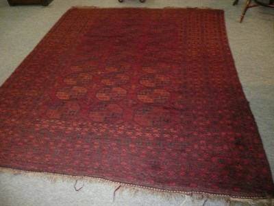 Lot 566 - Afghan Turkman carpet, the madder field with columns of guls