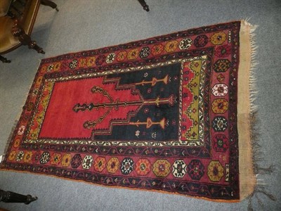 Lot 583 - Anatolian prayer rug, the stepped crimson field beneath a Mihrab