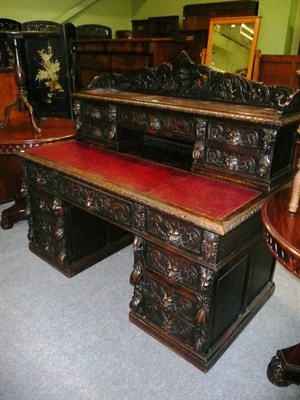 Lot 605 - Victorian carved oak desk with raised back