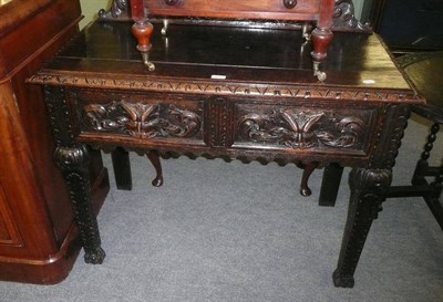 Lot 630 - Carved oak two drawer side table