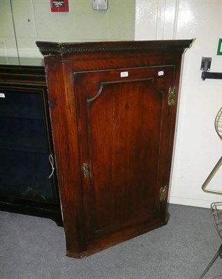 Lot 636 - George III oak hanging corner cupboard