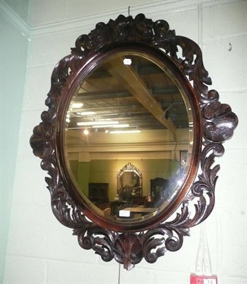 Lot 637 - Carved oak wall mirror