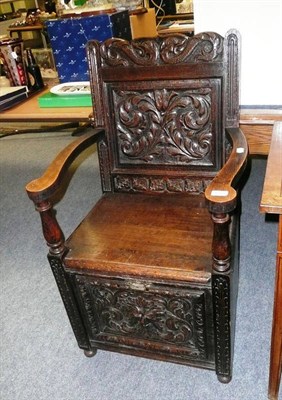 Lot 650 - Carved oak chair purdonium