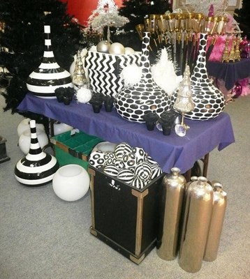 Lot 1014 - Decorations including, Eight wax floating candle holders, black urns, large black vase, pair of...