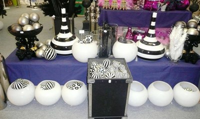 Lot 1022 - Decorations including, Black and white including four stripey vases, two resin slave bowls,...