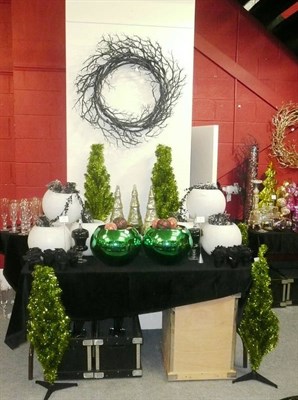 Lot 1042 - Decorations including, A black wreath, four green tinsel trees, two green spherical vases,...