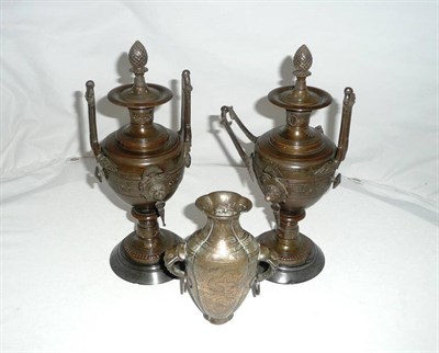 Lot 20 - Two bronze two handled urns and covers and a bronzed flask (3)
