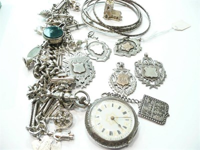Lot 76 - A silver albert with fob watch, shields, bangles and a charm bracelet