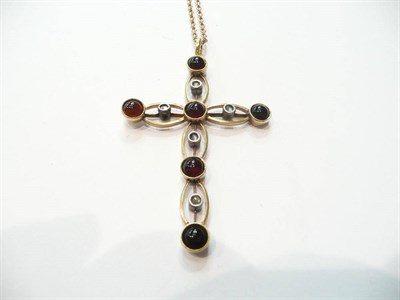 Lot 82 - A garnet and diamond cross on a chain