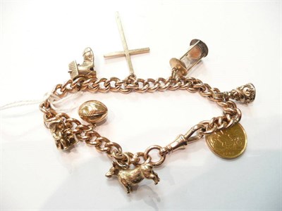 Lot 84 - A charm bracelet hung with seven charms and a soldered 1905 half sovereign