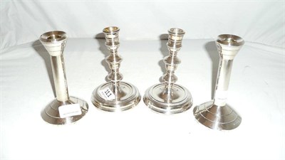 Lot 111 - Two pairs of silver-mounted candlesticks