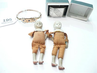 Lot 195 - A 9ct hollow bangle, a silver napkin ring, two small Japanese dolls