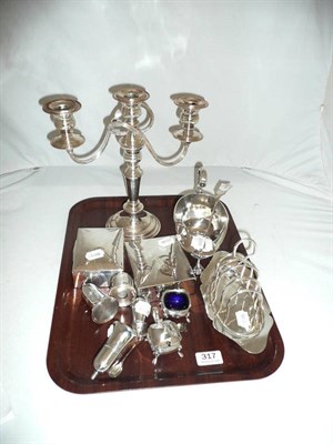 Lot 317 - A plated candelabra, a sauce boat, three ladles, a quantity of small plates, two silver plated...