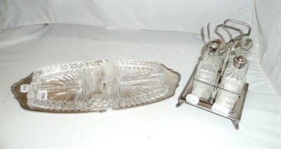 Lot 336 - Silver hors d'oeuvres dish with fitted glass trays and a plated four bottle cruet stand (2)