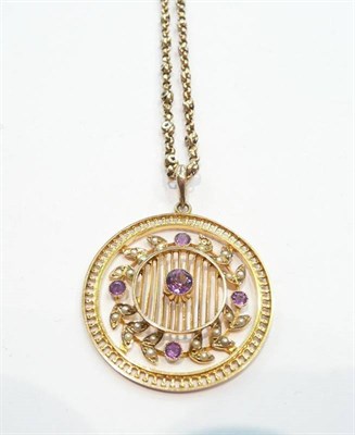 Lot 365 - An amethyst and seed pearl pendant on a fancy chain