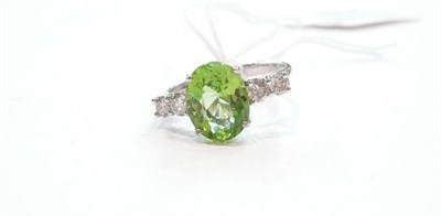 Lot 374 - A 14ct white gold, peridot and diamond ring