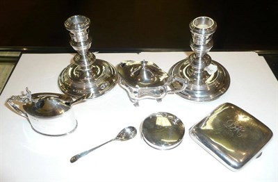 Lot 379 - Two silver mustard pots, a cigarette case, a circular box, a pair of loaded candlesticks