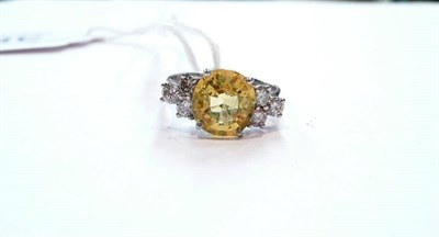 Lot 388 - A 14ct white gold, yellow sapphire and diamond ring