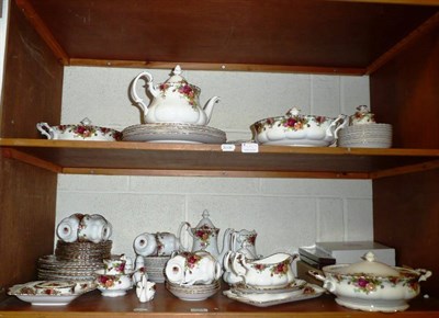 Lot 454 - A large quantity of Royal Albert Country Rose tea and dinner wares on two shelves