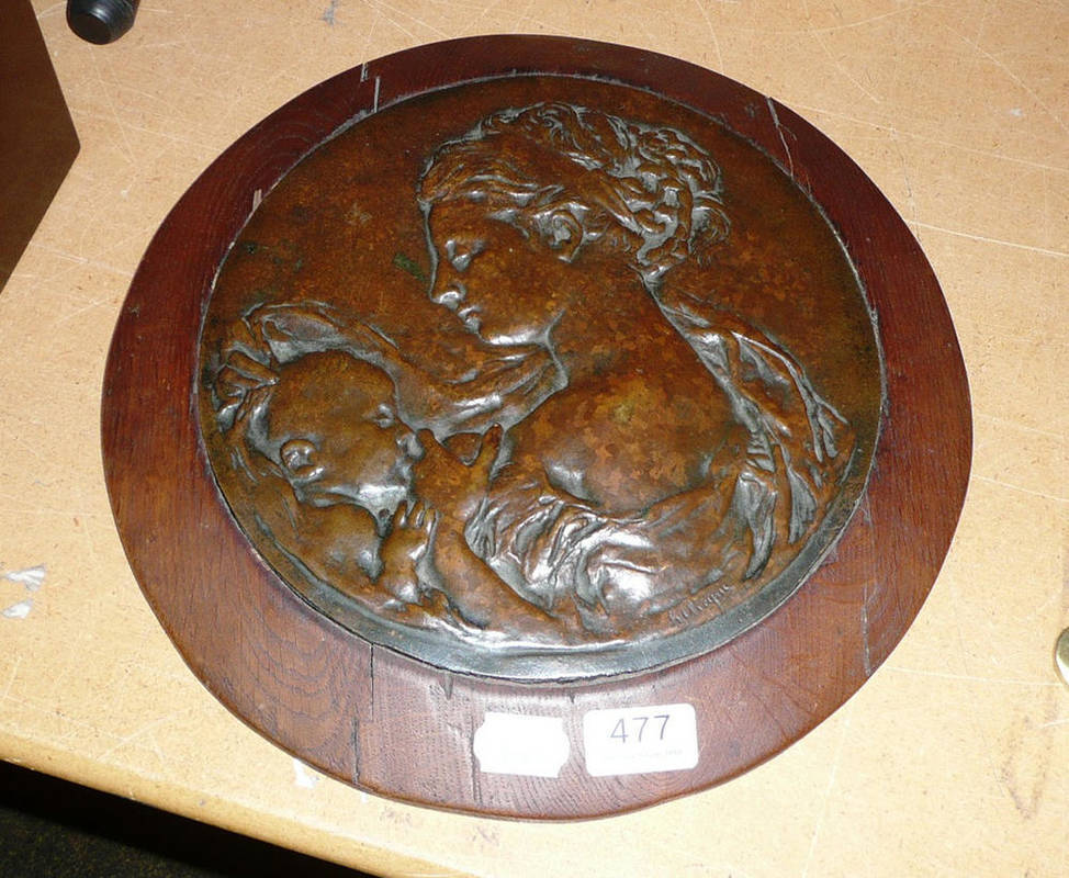 Lot 477 - Bronze circular plaque of a breast feeding mother