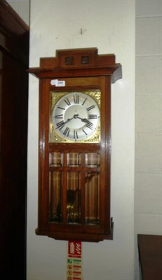 Lot 589 - Oak wall clock with brass and silvered dial