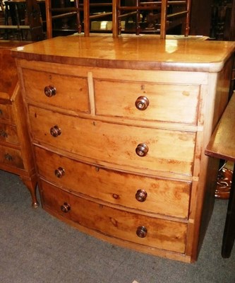 Lot 604 - An elm wood bow front chest of drawers