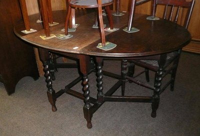 Lot 608 - An Edwardian box-strung mahogany cake stand, a jardiniere stand and an oak gateleg table