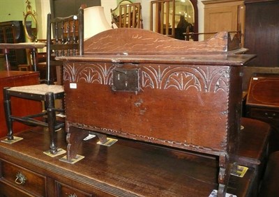 Lot 625 - Small carved oak hinged chest and a small spindle back chair (2)