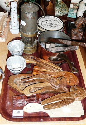 Lot 50 - Kitchenalia, comprising treen butter moulds, treen nutcrackers, butter pats, moulds, sugar...