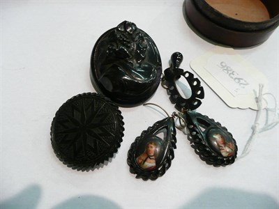 Lot 67 - A pair of jet earrings, a loose jet earring, a cameo jet brooch and another brooch