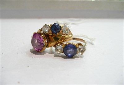 Lot 69 - A blue cabochon sapphire and white stone three stone ring, a sapphire and paste three stone...