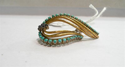 Lot 76 - A sapphire and turquoise swirl brooch, stamped "750"