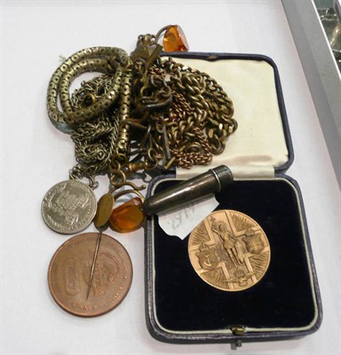 Lot 86 - A quantity of plated chains, medals and a silver cigarette holder