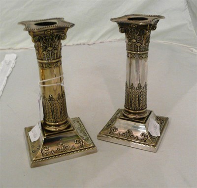 Lot 190 - A pair of silver plated corinthian column candlesticks, Hawksworth, Eyre & Co.