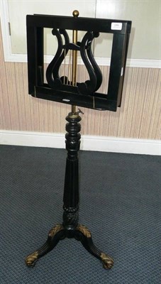 Lot 245 - An Ebonised and Parcel Gilt Adjustable Duet Stand, with turned, reeded and foliate carved...