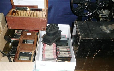 Lot 331 - A Tinplate and Lacquered Brass Magic Lantern, with electric adaptor and three lenses, in a tinplate