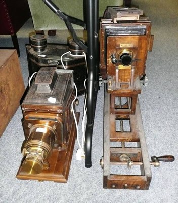 Lot 341 - A Victorian Mahogany, Brass and Tinplate Magic Lantern, the panelled side doors with blue glass...