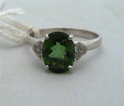 Lot 436 - An 18 carat white gold green tourmaline and diamond cluster ring