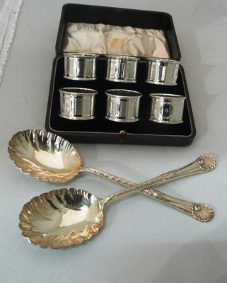 Lot 547 - Six napkin rings, cased, Birmingham 1904; and pair of fruit spoons, Walker & Hall, Sheffield 1897