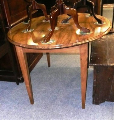 Lot 666 - An oval mahogany drop leaf dining table