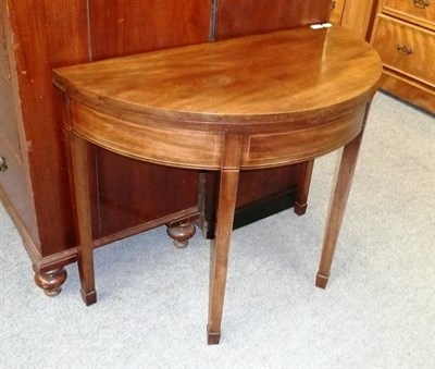 Lot 746 - A George III mahogany demi-lune card table on square tapering legs