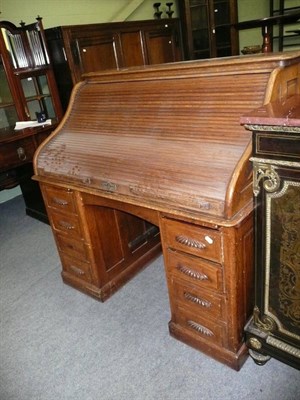 Lot 753 - Early 20th century oak roll top desk