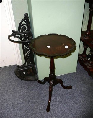 Lot 794 - Cast iron stick stand, mahogany tripod table and a copper coal helmet